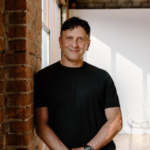 Fertility specialist at Victory Reproductive Care, portrait by a brick wall, supporting patients using the Ontario fertility tax credit.