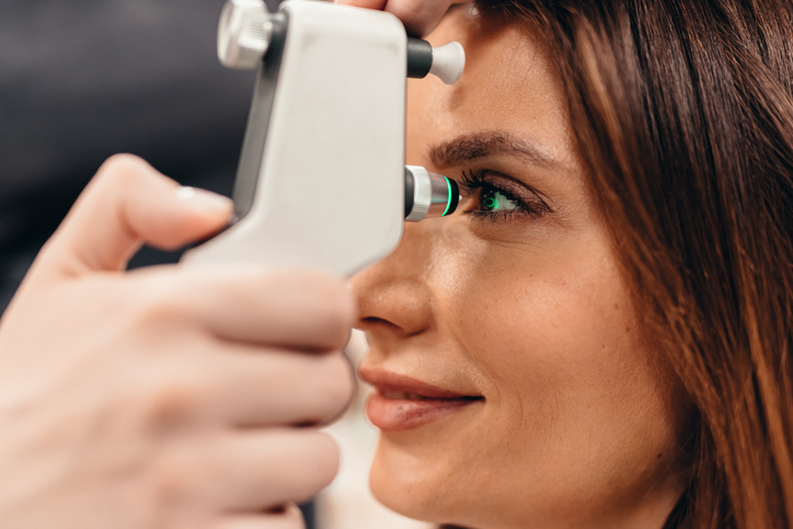 Close-up of a clinician using a diagnostic device to examine a woman’s eye during a PRK laser eye surgery consultation at Clearview Eye Centre.