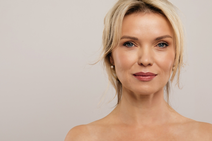 Mature woman smiling confidently after facelift treatment at Clinic 805 in Victoria, BC